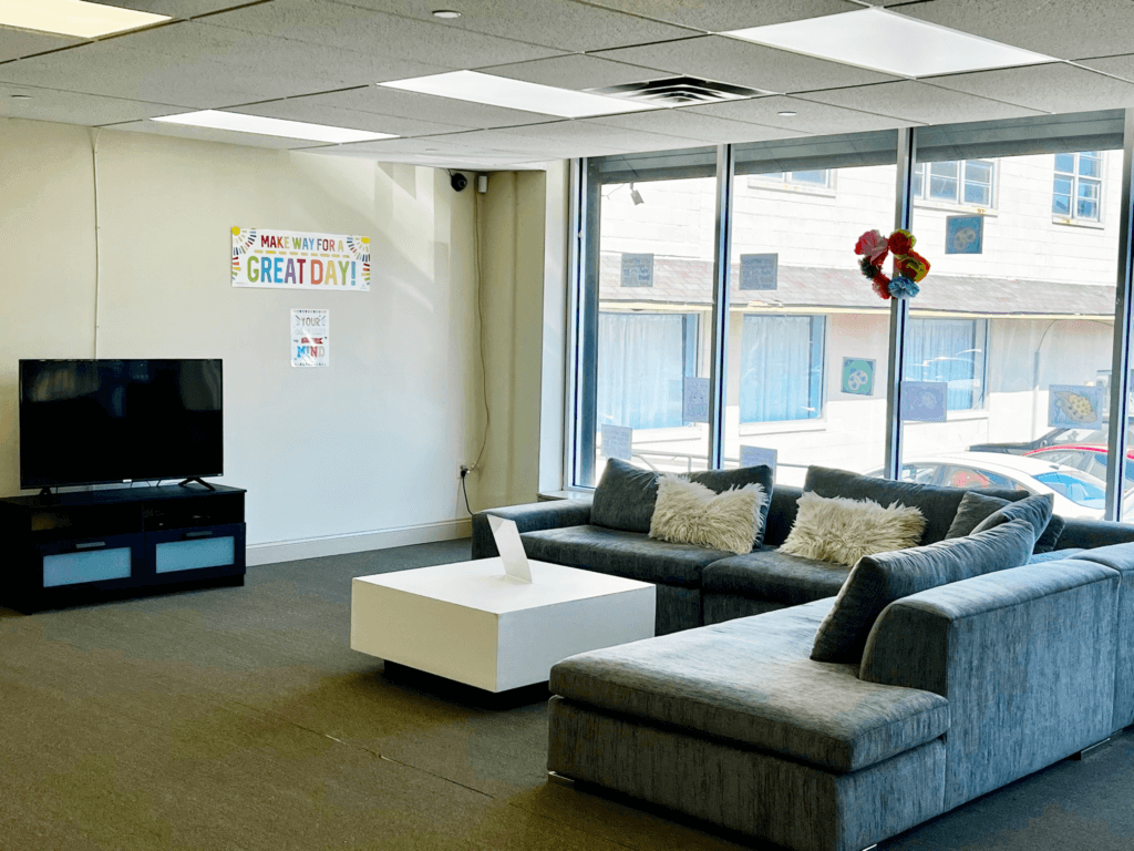 The lounge and welcome area at Penn Village with sofas, a television and large windows