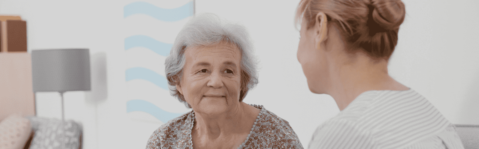 elderly woman talking to nurse