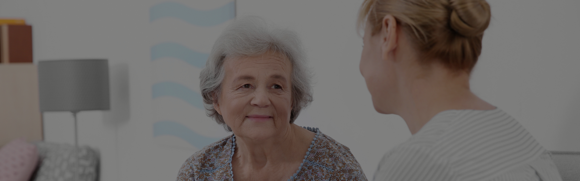 elderly woman talking to nurse